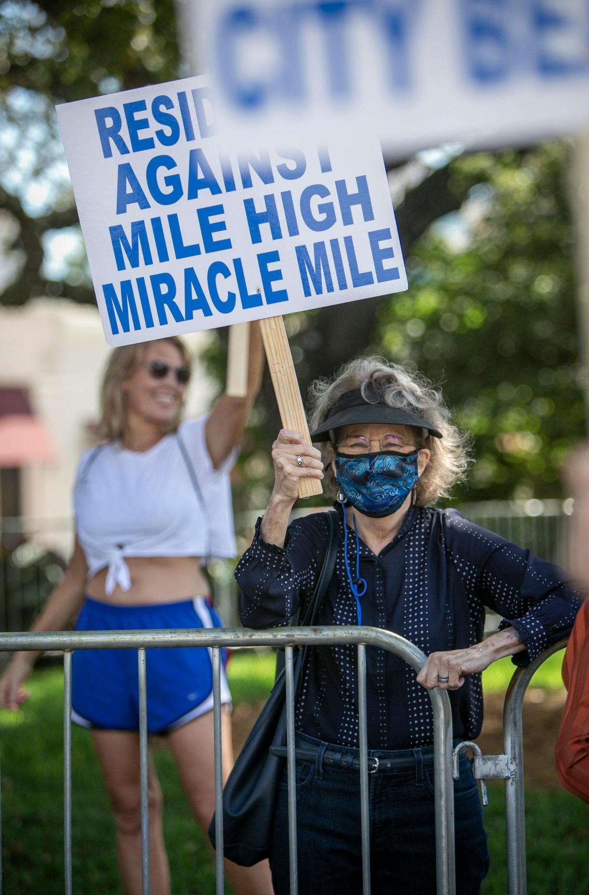 Jane Moscowitz, right, carries her sign during a protest in front of Coral Gables City Hall on Tuesday, February 9. Residents and activists are protesting a vote over a change in the zoning code that would affect development on Miracle Mile.