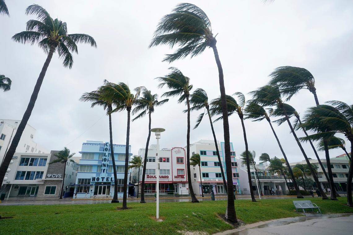 Palm trees sway in the wind in front of historic Art Deco hotels, Sunday, Nov. 8, 2020, on Miami Beach, Florida’s famed South Beach. A strengthening Tropical Storm Eta cut across Cuba on Sunday, and forecasters said it was likely to be a hurricane before hitting the Florida Keys Sunday night or Monday.