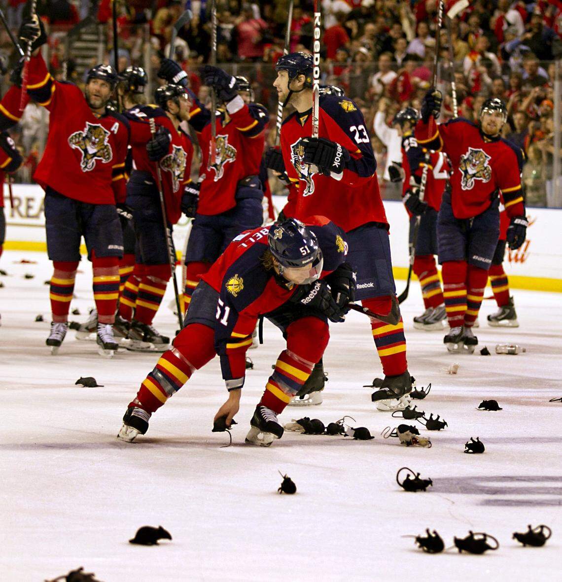 Florida Panthers defenseman Brian Campbell (51) scoops up a keepsake rat after the win over the New Jersey Devils at Bank Atlantic Center in Sunrise on April 21,2012.