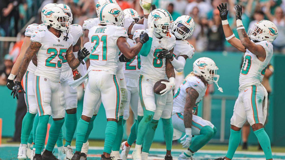 Miami Dolphins free safety Jevon Holland (8) celebrates with teammates in the end zone after intercepting the ball in the second quarter during game against the Carolina Panthers at Hard Rock Stadium on Sunday, November 28, 2021.