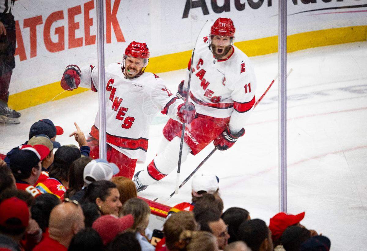 Carolina Hurricanes center Logan Stankoven (22) celebrates his goal and center Jordan Staal (11) cheers in the second period of Game 4 during the Eastern Conference final of the NHL Stanley Cup playoffs against the Florida Panthers at the Amerant Bank Arena on Monday, May 26, 2025 in Sunrise, Fla.