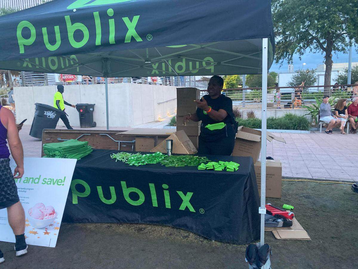 Publix representatives hand out swag during a stop at a Tampa park in 2023.