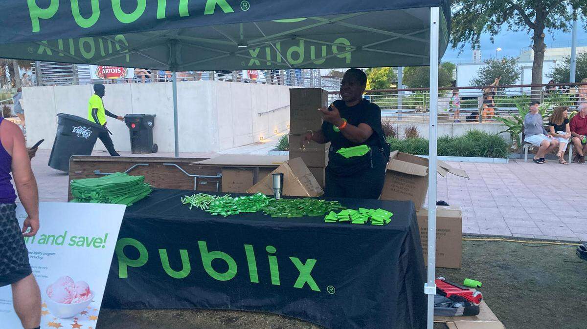 Publix representatives hand out swag during a stop at a Tampa park in 2023.