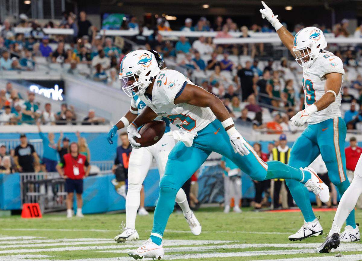 Miami Dolphins running back Chris Brooks (33) scores in the fourth quarter against the Jacksonville Jaguars in the fourth quarter at EverBank in Jacksonville, Florida on Saturday, August 26, 2023.