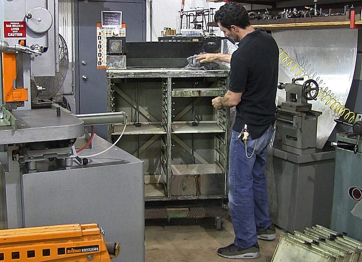 Jesse Brody, an adjunct professor at Florida International University, has stumbled upon a treasure chest inside this old dentist cabinet he salvaged from demolition years ago. Brody, a craftsman who owns a high-end furniture store in Miami Beach, kept the old cabinet in his workshop for several years before deciding to work on it. What he found inside: an old passport from the 1940s, several golden coins, diamond rings, jewelry and cash in Miami on Wednesday, Oct. 3, 2018.