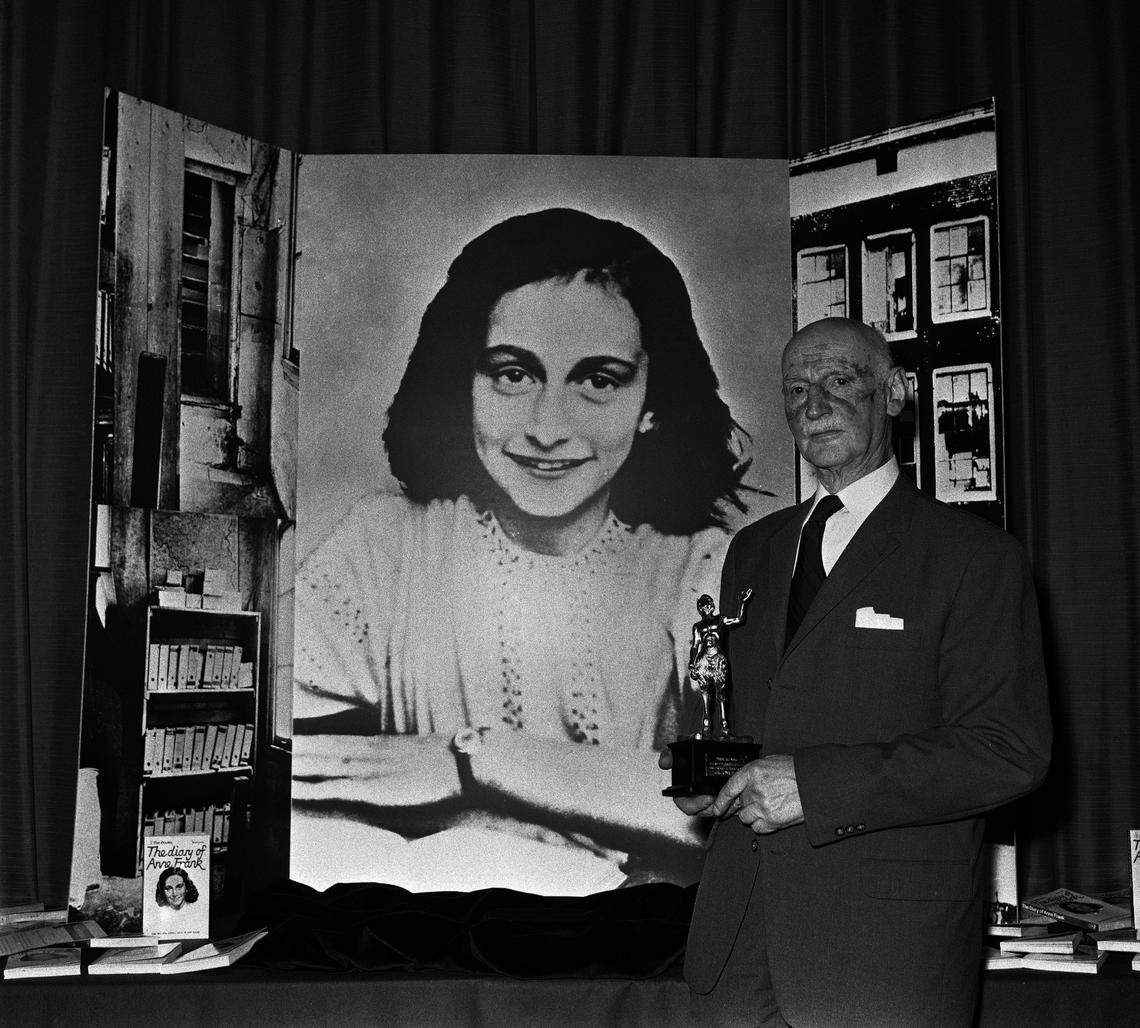 Otto Frank, Anne’s father and the family’s only survivor, stands in front of a photo of Anne Frank while accepting an award for “The Diary of Anne Frank” in London in 1971.
