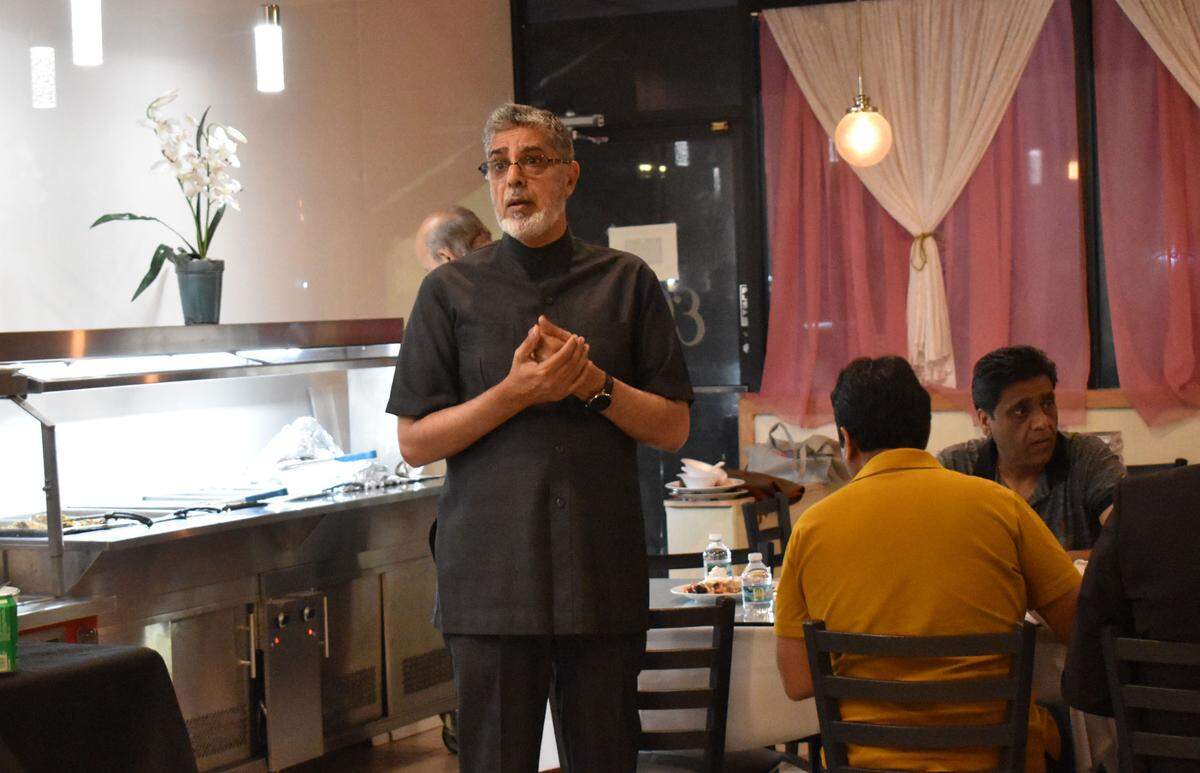 Mian Mushtaq Javed, Akhuwat’s Eastern U.S. representative, talks to members of South Florida’s Pakistani community, who gathered at Ellie’s Halal Restaurant in Cooper City on Thursday, Sept. 3, 2022. The community was fund-raising for those affected by the floods in Pakistan. 