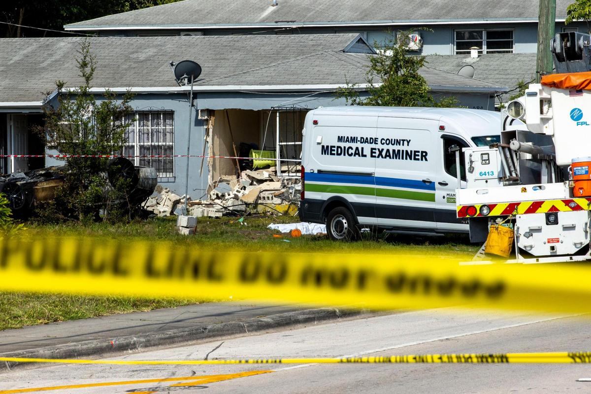 Miami-Dade County Medical Examiners respond to the scene where three people were killed and two others were injured after a car crashed into the bedroom of a home near Northeast 82nd Street and Third Avenue in Miami, Florida, on Wednesday, May 25, 2022.