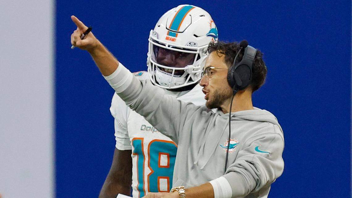 Miami Dolphins coach Mike McDaniel speaks with Miami Dolphins quarterback Tyler Huntley (18) during a timeout in the first half during an NFL football game in Indianapolis, Indiana on Sunday, October 20, 2024.