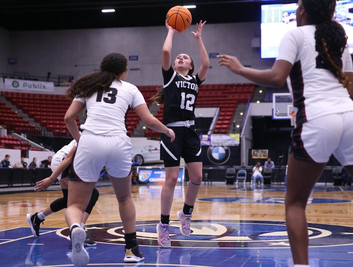 Miami Christian’s Ziul Gonzalez (12) sets up to shoot as Faith Christian defends in the Class 2A girls basketball state championship game at the RP Funding Center in Lakeland on Saturday, February 26, 2022.