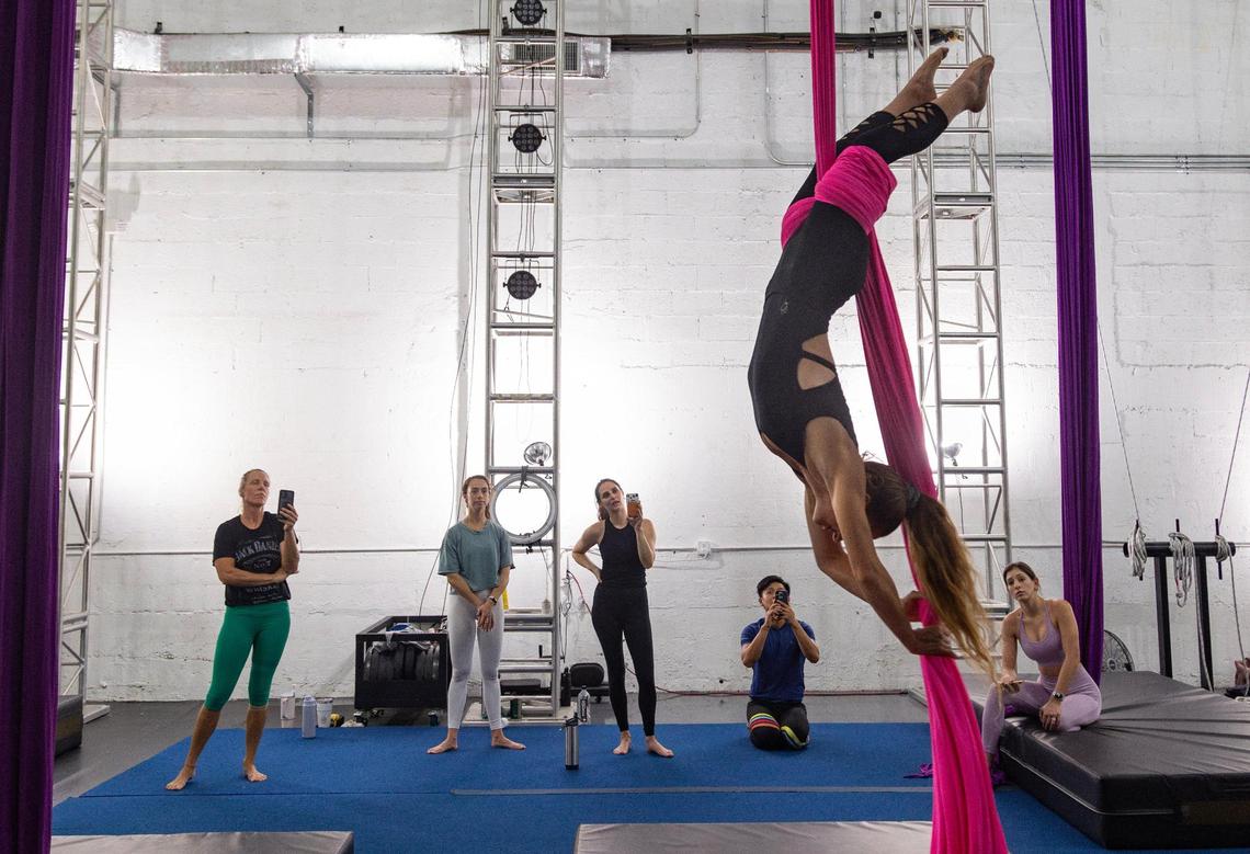 Mila Puletti shows students a figure eight stack drop during an adults silks class at the Miami Circus Arts Center on Aug. 19, 2023, in Miami, Fla. “I remember I was up there doing a drop on my first or second class and I was just like ‘Oh my God I’m gonna die! I’m gonna die!’” Puletti said. “You’re all the way up, and you have to think about throwing yourself out of something.”