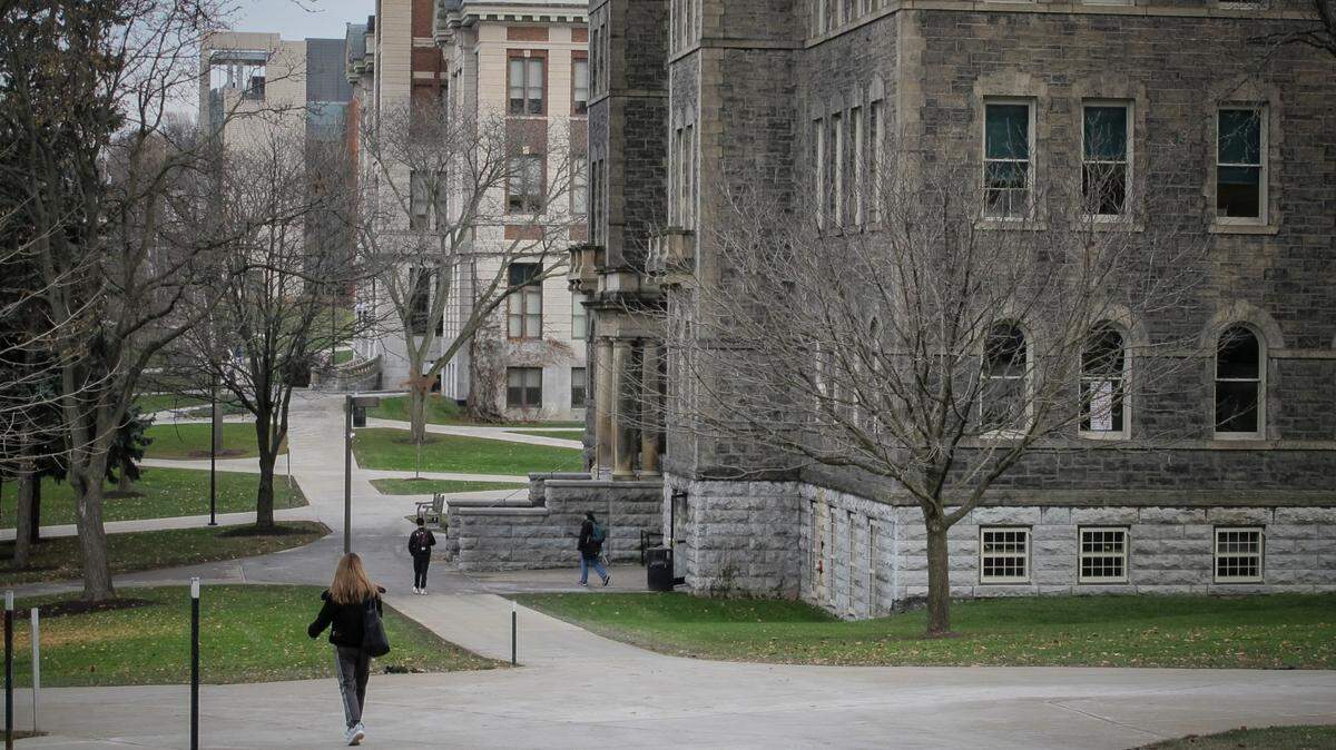 Students walk the campus on Syracuse University, Thursday, Nov. 21, 2019, in New York. Syracuse University students describe fear and anxiety as reports of racist graffiti and vandalism add up on campus. (AP Photo/Carolyn Thompson)