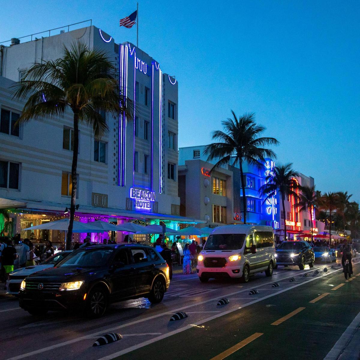 Cars head down Ocean Drive as crowds fill the sidewalk during spring break in Miami Beach on Saturday, March 19, 2022.