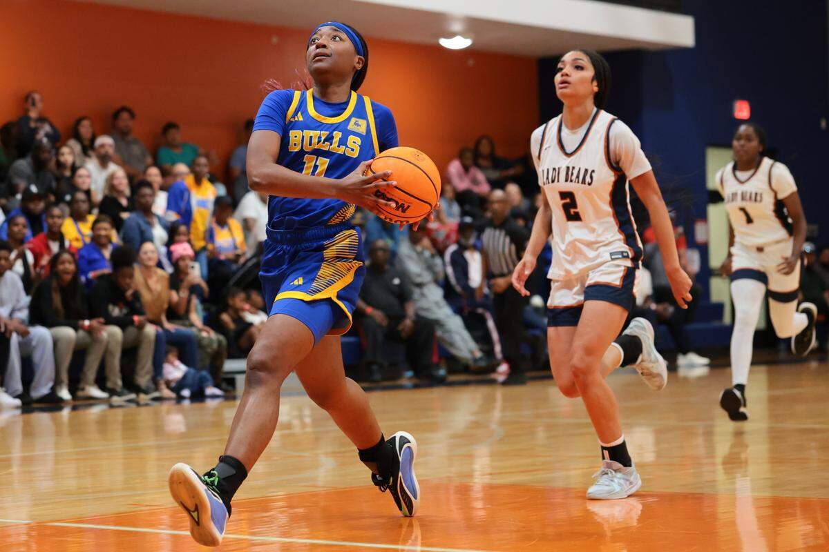 Northwestern Bulls Myah Newton (11) drives to the basket against the Mater Lakes Academy Bears in the third quarter during a girls' basketball Region 4-4A semifinal playoff game at Mater Lakes Academy on Friday, February, 20, 2026, in Hialeah, Fla.