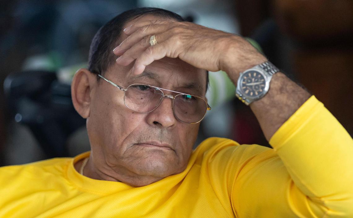 Miguel Herrera reacts as he listens to Vivian Hernandez, 61, recount the story of her arrest at her home in the Li’l Abner Mobile Home Park on Saturday, Dec. 21, 2024, in Sweetwater, Florida.
