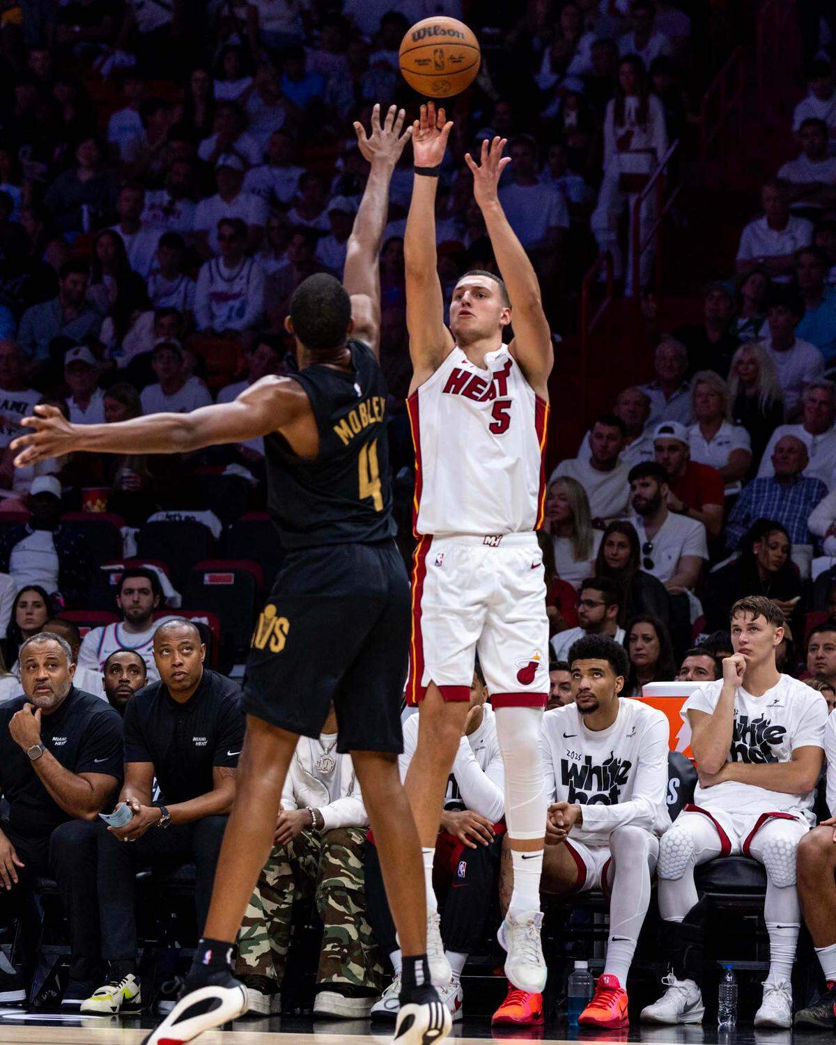 Miami Heat forward Nikola Jovic (5) shoots a three-pointer over Miami Heat guard Isaiah Stevens (4) during the second half of Game 4 of the Eastern Conference NBA Playoffs at Kaseya Center on Monday, April 28, 2025, in Miami, Fla.