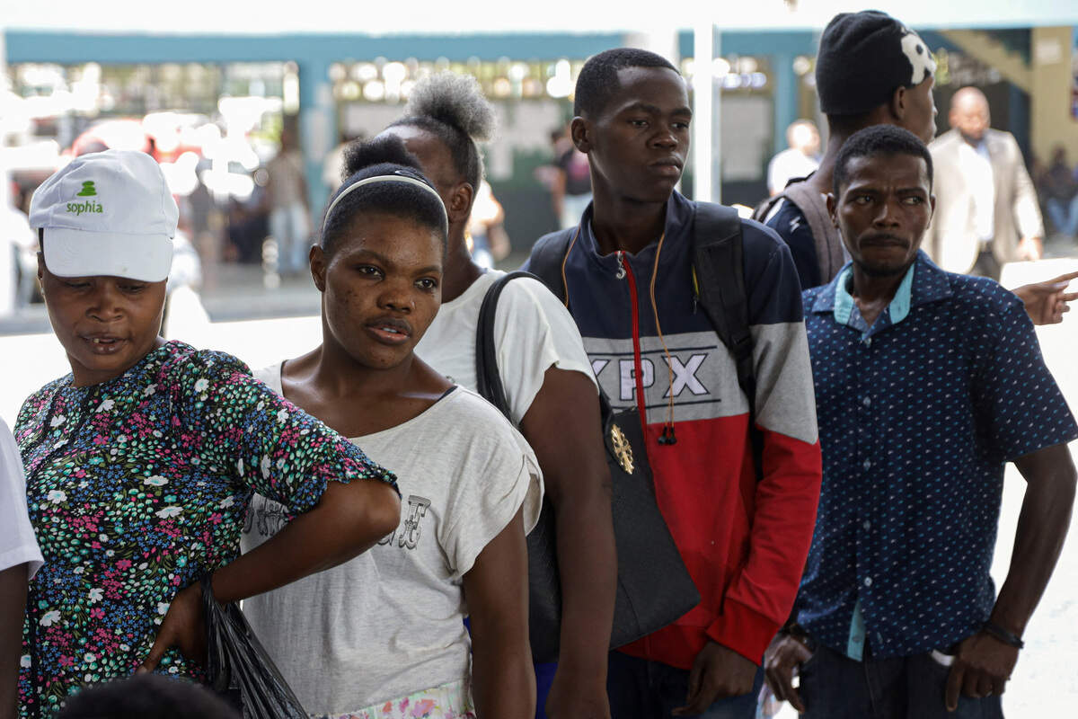 People line up at a voter registration site ahead of Haiti's first presidential election in a decade, in Port-au-Prince, Aug. 18, 2026.