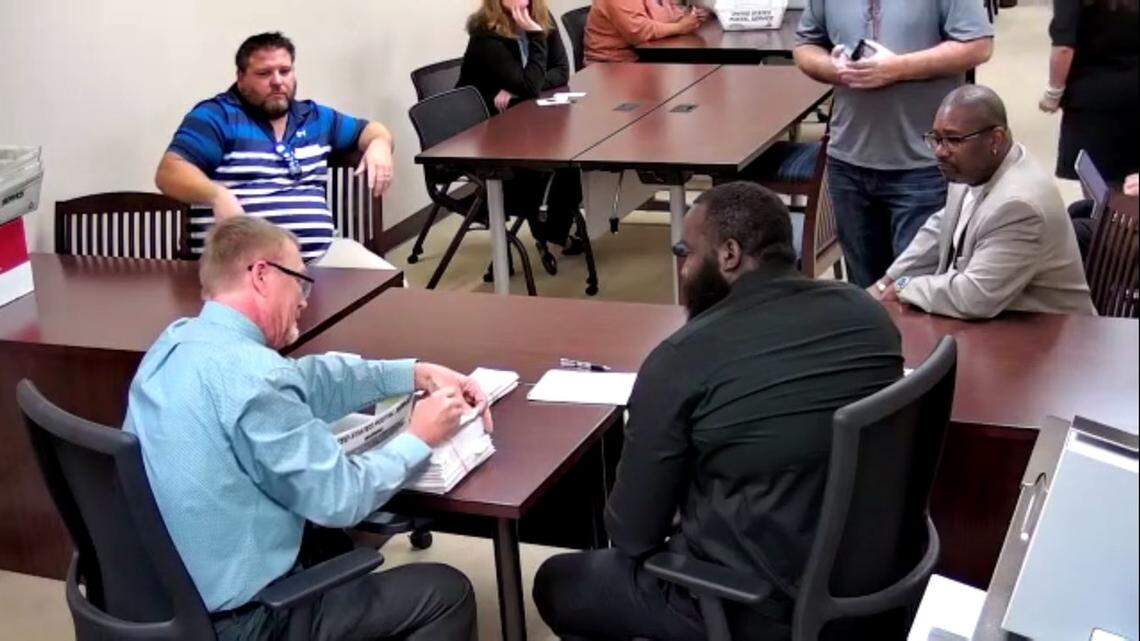 Eddie Johnson, who oversees elections at the Public Employees Relations Committee, counts ballots at the certification election for the United Teachers of Dade. Representatives from the United Teachers of Dade and the Freedom Foundation were present at the count.