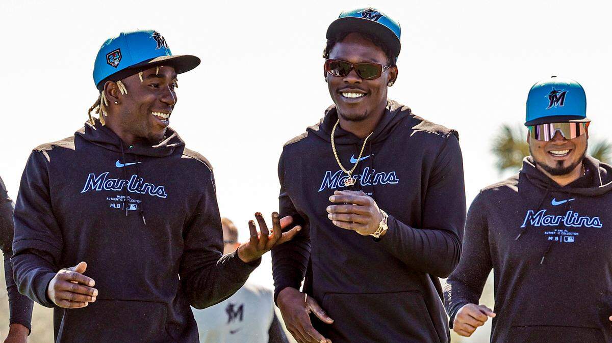Miami Marlins, Nick Gordon, Jazz Chisholm Jr., and Luis Arraez, left to right, sprint during warmups at spring training at Roger Dean Chevrolet Stadium in Jupiter, Florida on Tuesday, February 20, 2024.