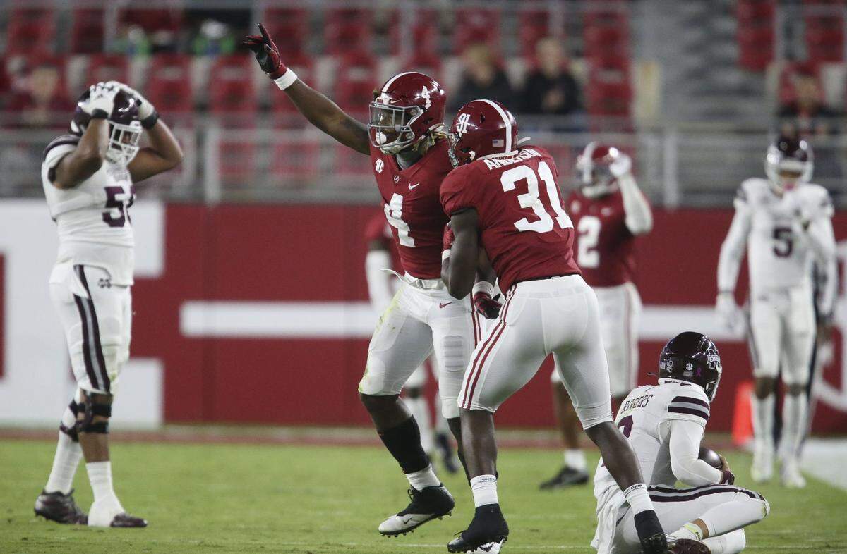 Alabama linebacker Christopher Allen (4) celebrates with linebacker Will Anderson Jr. (31) after he sacked Mississippi State quarterback Will Rogers (2) for a loss during an NCAA college football game Saturday, Oct. 31, 2020, in Tuscaloosa, Ala. (Gary Cosby Jr./The Tuscaloosa News via AP)