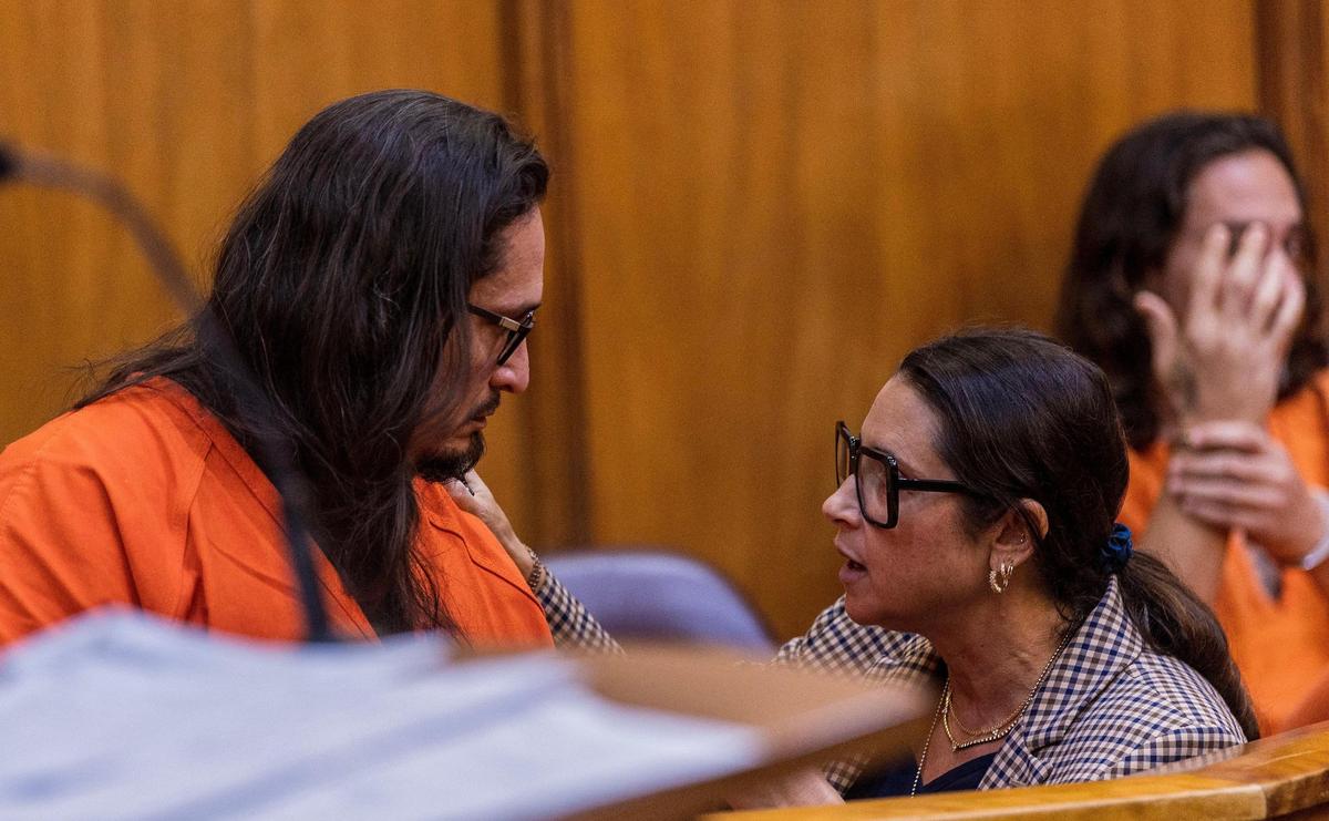 Victor Hernan Majano Bejarano speaks with his attorney Andrea Wagner on Monday, Jan. 29, 2024, in Miami criminal court as his defense team prepares for a hearing Wednesday to try and get him out of jail before trial.