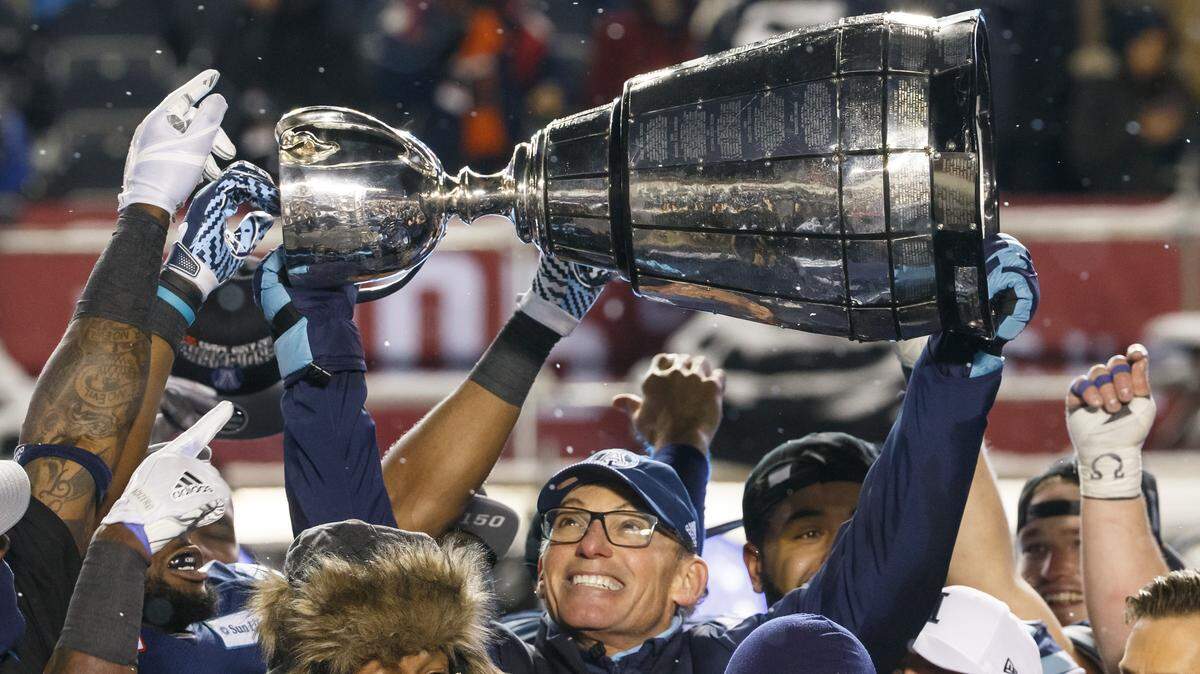 Toronto Argonauts head coach Marc Trestman raises the Grey Cup over his head as he celebrates winning the 105th Grey Cup Championship Game against the Calgary Stampeders at TD Place Stadium on November 26, 2017 in Ottawa, Canada. (Andre Ringuette/Getty Images/TNS)