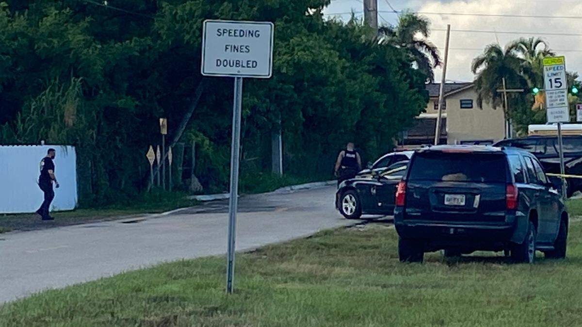 Miami-Dade police officers and federal agents stand outside a gated home at the 24000 block of SW 124th Avenue near Homestead Tuesday morning, Aug. 27, 2024. According to Miami-Dade police, officers were assisting the FBI with a search warrant at the house. 