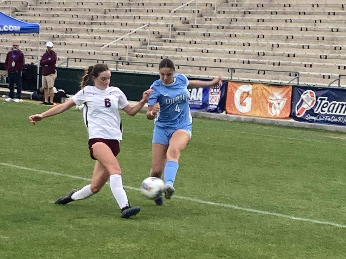 Lourdes’ Catherine Esquijerosa battles Chiles defender Nolyn Haley for possession in the corner during Saturday's Class 6A girls’ soccer state championship game at Spec Martin Stadium in DeLand, Fla.