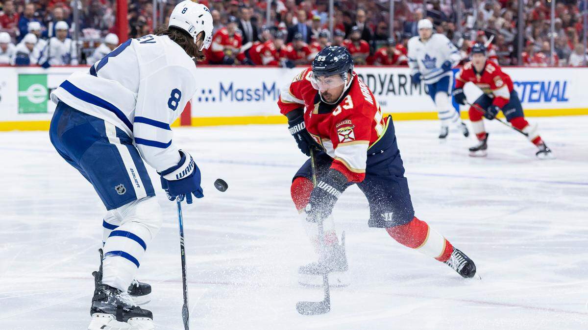 Florida Panthers center Brad Marchand (63) and Toronto Maple Leafs defenseman Chris Tanev (8) compete for the puck in the first period of Game 6 of a second-round Stanley Cup playoffs series at the Amerant Bank Arena on Friday, May 16, 2025, in Sunrise, Fla.