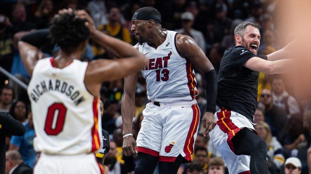 Miami Heat center Bam Adebayo (13) and forward Kevin Love (42) celebrate during a timeout in the second half against the Indiana Pacers at Gainbridge Fieldhouse.