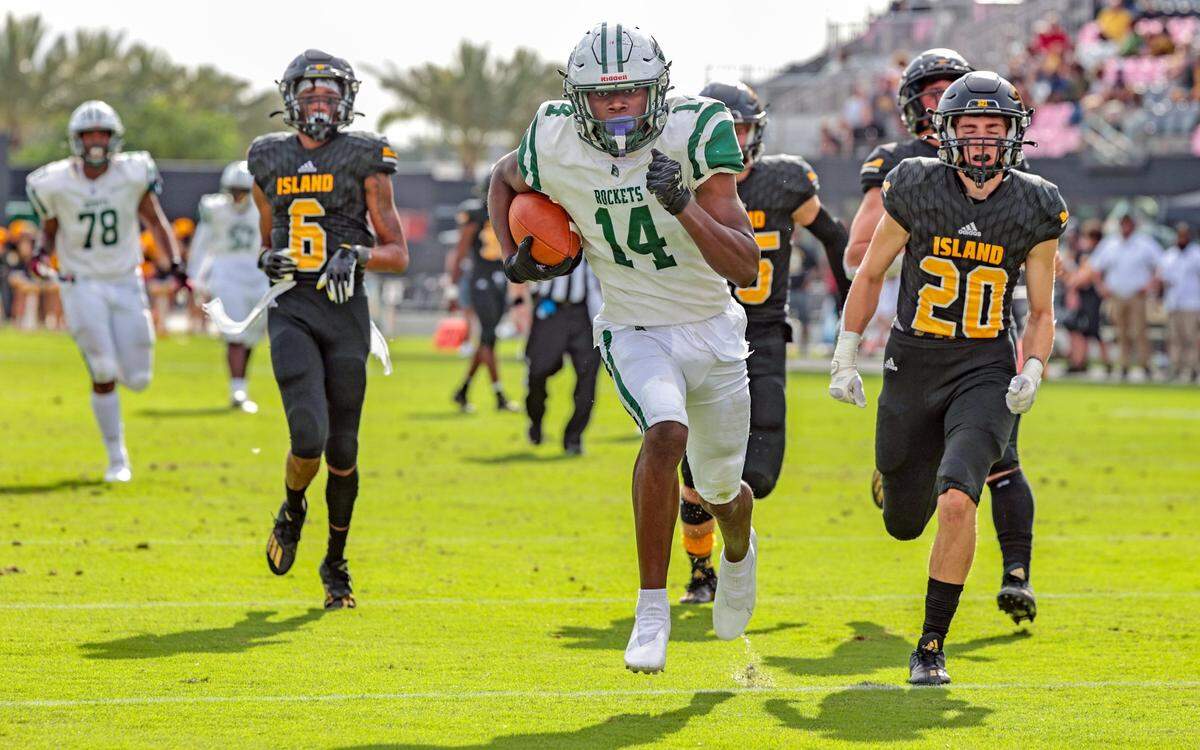 Miami Central High School wide receiver Lamar Seymore (14), scores in the second quarter as Merritt Island High School gives chase in the FHSAA Class 5A State Championship at DRV PNK Stadium, in Fort Lauderdale on Friday, December 17, 2021.
