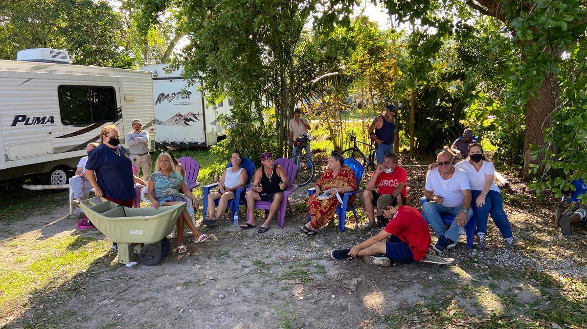 Residents of Florida City Trailer and RV Park gather in a lot Monday evening, March 15, 2021, to discuss their possible eviction at the hands of the city.