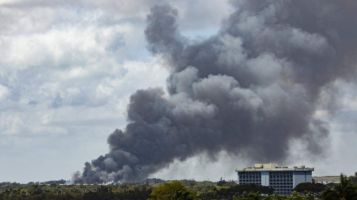 Firefighters work to contain a fire at a six-story warehouse on Thursday, March 5, 2026, in Miami Gardens, Fla.