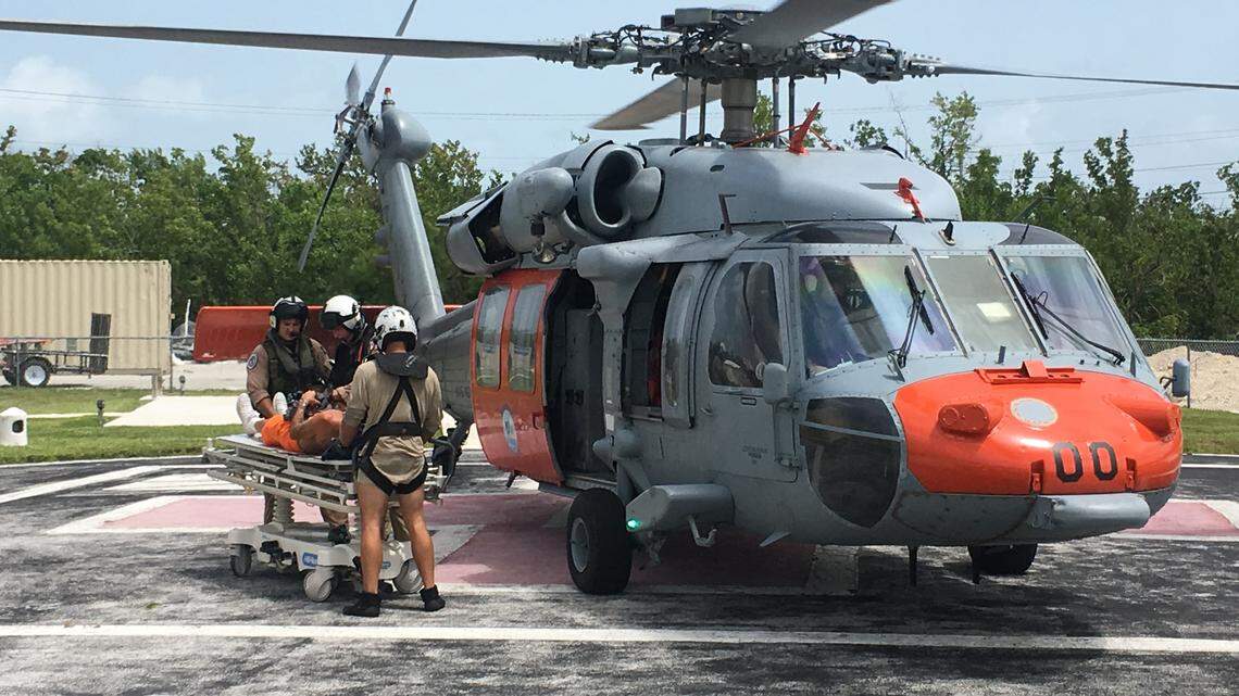 Naval Air Station Key West Search and Rescue crew members transport a possible heart attack victim to Lower Keys Medical Center on Aug. 9, 2018.