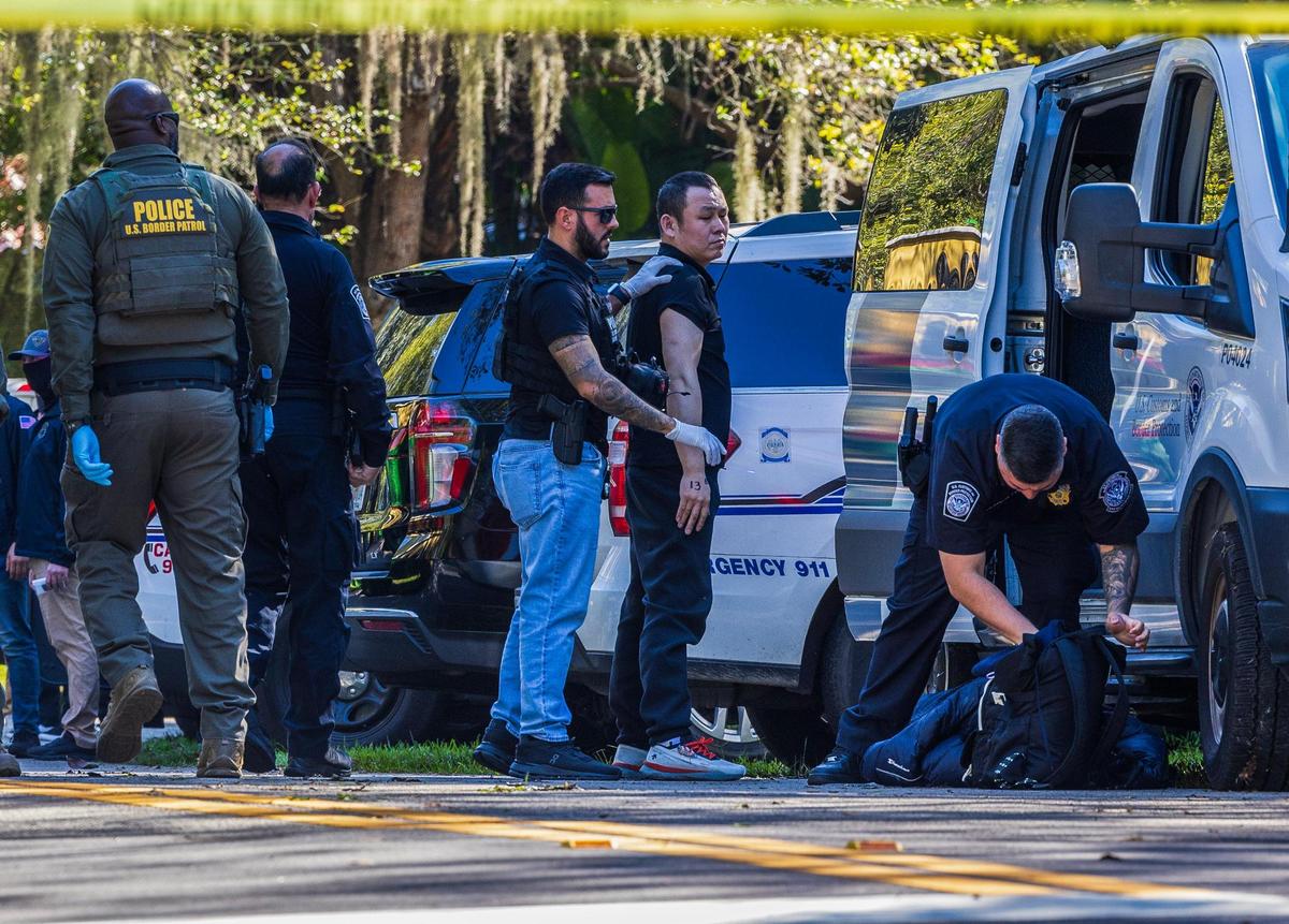 Multiple law enforcement officers processed a group of illegal migrants and two suspected smugglers arrested at 11600 Old Cutler Road in Coral Gables early morning, on Tuesday, January 28, 2025. On Wednesday, federal agents said a total of four suspected smugglers were arrested.
