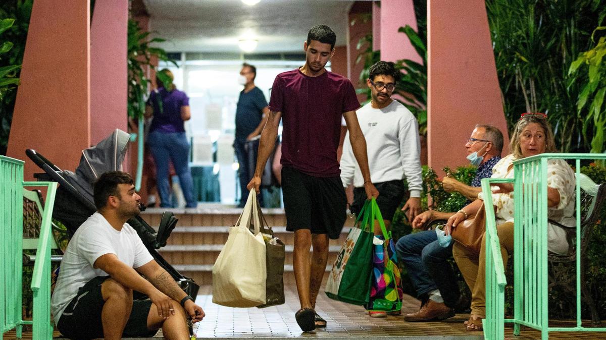 Cristian, the grandson of an elderly resident, carries personal items as all residents from a 138-unit condo at 5050 NW Seventh St. in Flagami were forced to evacuate Aug. 9, 2021, after city officials deemed the building unsafe.
