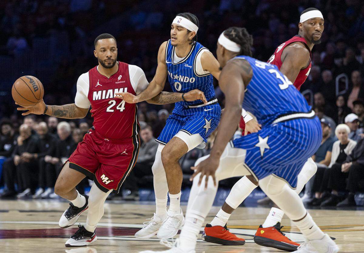 Miami Heat guard Norman Powell (24) drives the ball as Orlando Magic guard Anthony Black (0) defends in the first half of their NBA game at the Kaseya Center on Jan. 28, 2026, in Miami.