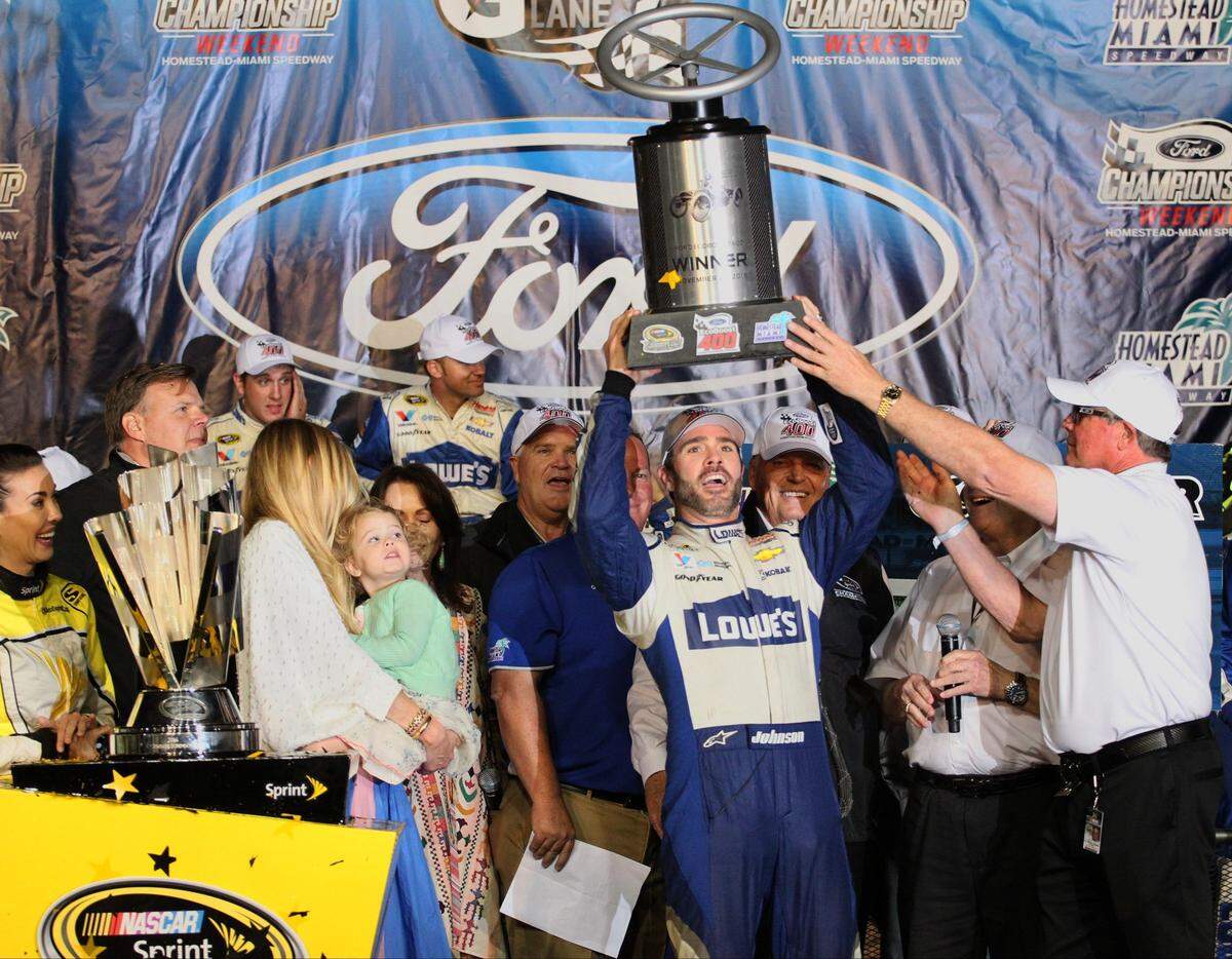 Jimmie Johnson host the Series Ford EcoBoost 400 Championship trophy after his victory. Johnson claimed his 7th NASCAR Sprint Cup Series Championship at Homestead-Miami Speedway on Sunday, November 20, 2016.