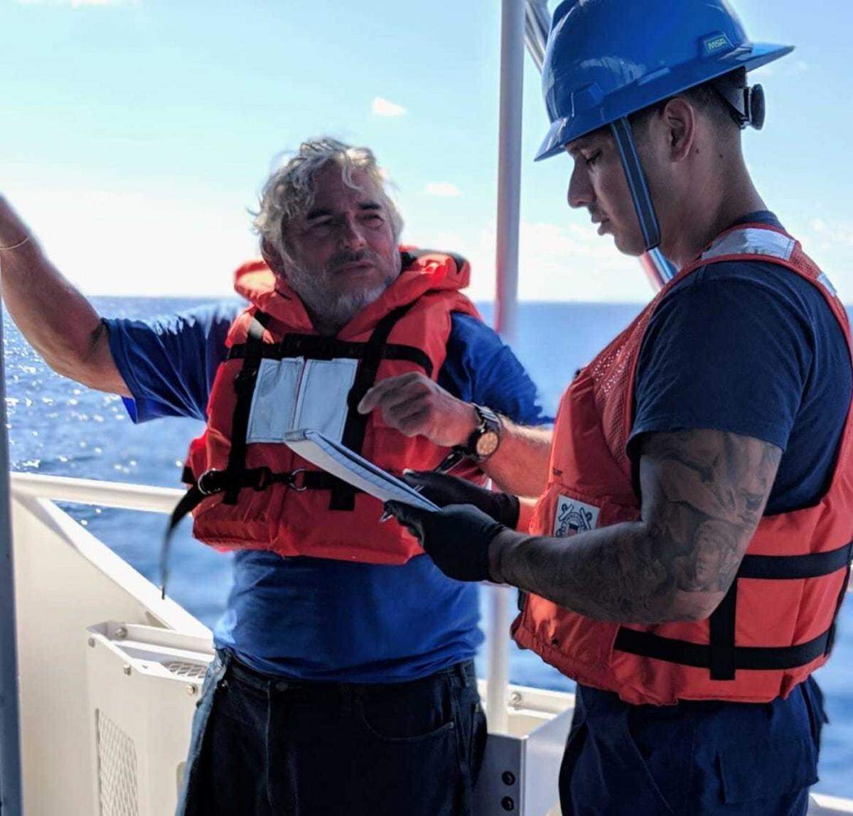 Luis Erosa, left, reports the incident after being rescued Tuesday, Nov. 20, 2018, by the Coast Guard Cutter Terrell Horne (WPC-1131).