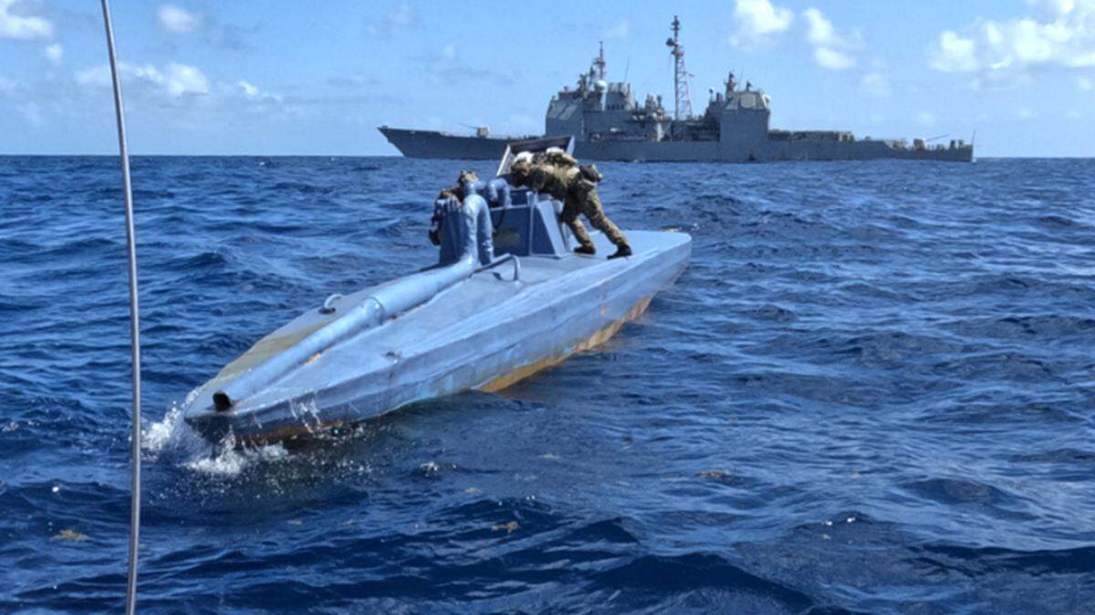 Coast Guard members who were deployed on the U.S. Navy’s USS Leyte Gulf board a semi-submersible vessel in the Atlantic in March 2024. The vessel had 600 kilograms of cocaine aboard, according to the Navy.