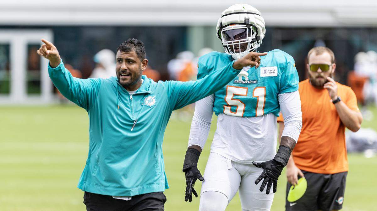 Miami Dolphins linebackers coach Ryan Crow works with linebacker Emmanuel Ogbah (51) during practice drills at Baptist Health Training Complex in Miami Gardens,FL on Saturday, August 3, 2024. 
