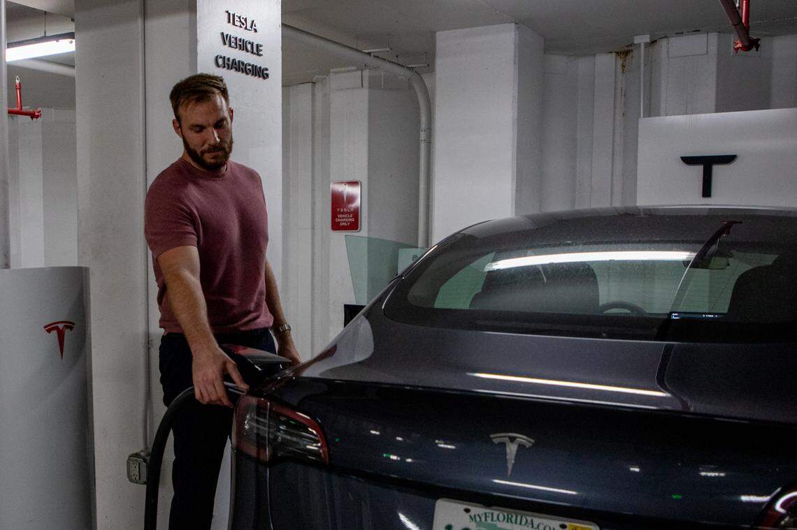 Clayton Williams charges his Tesla at a supercharger in the Brickell City Center on Friday, Sep. 23. He prefers to drive to the parking garage rather than using the charger at his apartment complex because it takes less time out of his day.