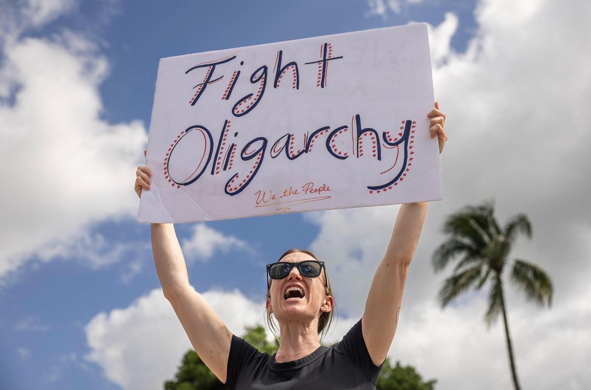 Brenda Aldana chants as she attends a National Day of Action protest against President Donald Trump and his administration at the Torch of Friendship on Saturday, April 19, 2025, in downtown Miami, Fla.