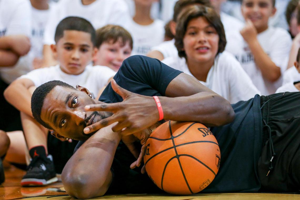 Miami Heat center Bam Adebayo is photographed with a basketball lying down in front of a group of campers during the Bam Adebayo’s fourth annual youth basketball clinic at Riviera Preparatory School on 9775 SW 87th Ave., in Miami, Florida on Saturday, July 30, 2022.