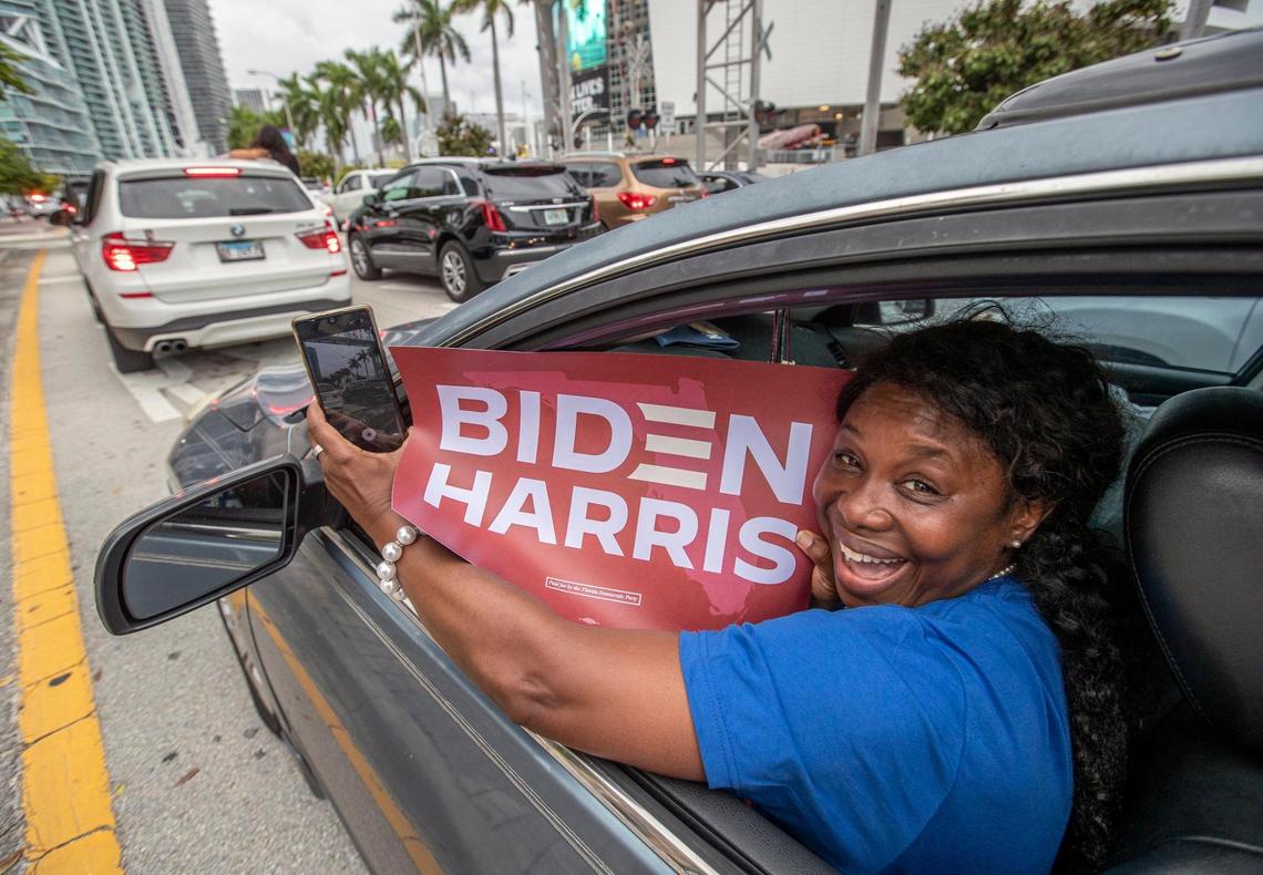 Stacey Dean joins the celebrations as they break out along Biscayne Blvd in downtown Miami after Joe Biden wins the presidency over President Trump on Saturday, November 7, 2020.