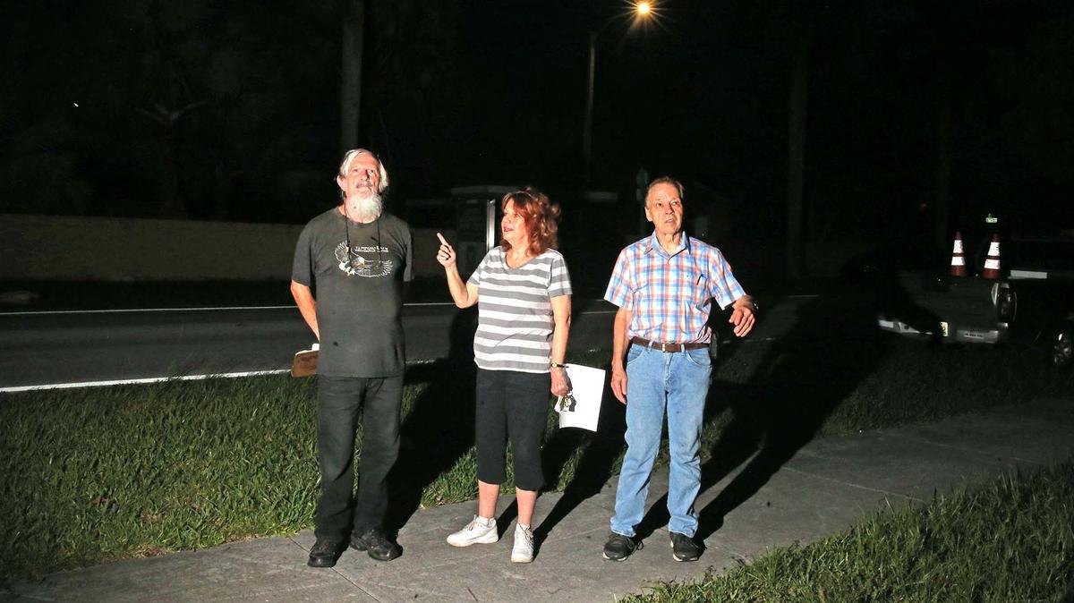 Robert Holley, Susan Blake and Rene Oppeneiger, discuss the street lights at Southwest 112th Avenue and 165th Terrace in South Miami-Dade, June 20, 2019. They are opposed to the new LED lights replacing the sodium vapor lights.