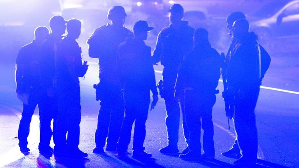 Law-enforcement officers gather at the scene of a mass shooting at a bar in Thousand Oaks, California.