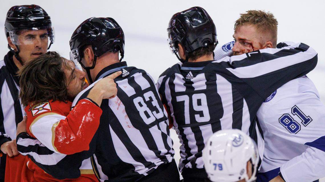 Florida Panthers left wing Ryan Lomberg (94) and Tampa Bay Lightning defenseman Erik Cernak (81) grab at each other as officials trying to separate them during the third period of an NHL game at the FLA Live Arena on Sunday, April 24, 2022 in Sunrise, Fl.