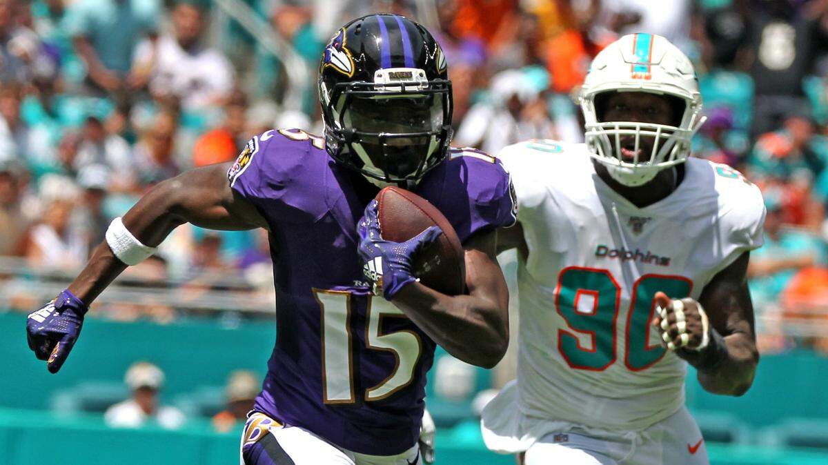 Miami Dolphins defensive end Charles Harris (90) chases Baltimore Ravens Marquise Brown (15) as he runs for a first quarter touchdown at Hard Rock Stadium in Miami Gardens, Florida, Sunday, September, 8, 2019.