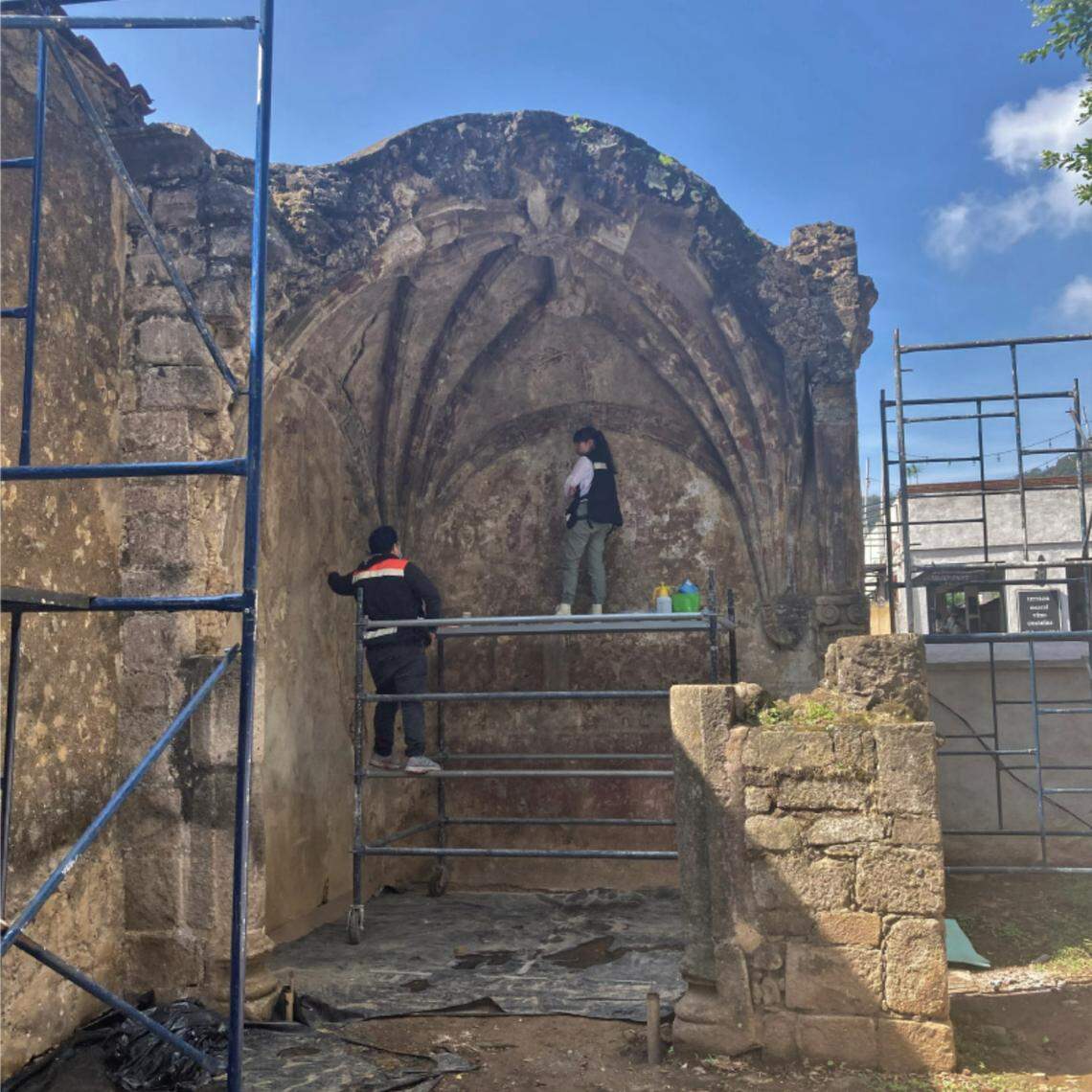 Archaeologists working to uncover the murals on the walls of the open-air chapels.